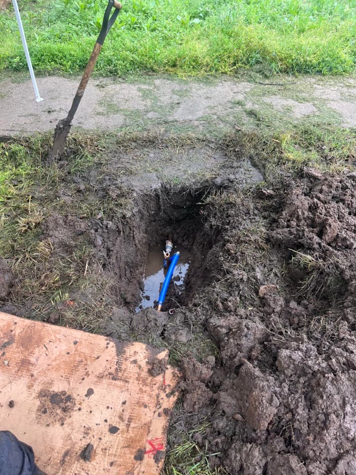 Exposed underground plumbing line during repair